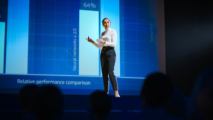 Aufkleber - On Stage, Successful Female Speaker Presents Technological Product, Uses Remote Control for Presentation, Showing Infographics, Statistics Animation on Screen. Live Event / Device Release.