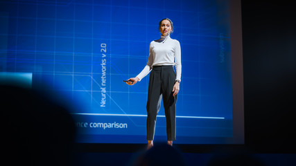 Aufkleber - On-Stage Successful Female Speaker Presents Technological Product, Uses Remote Control for Presentation, Showing Infographics, Statistics Animation on Big Screen. Live Event / Business Conference