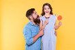 © be free - Yum. Father look at happy child yellow background. Little child eat lollipops. Raising child with love. Child care. Come together as family and enjoy. International childrens day