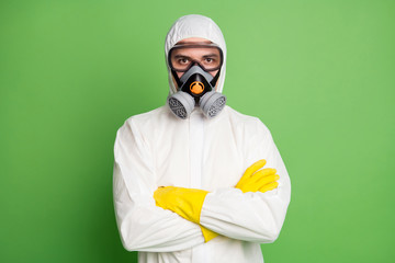 Canvas Print - Portrait of medical worker man cross hands ready stop covid19 epidemic spreading wear hazmat uniform isolated over green color background