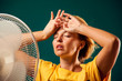© Aleksej - A portrait of woman in front of fan suffering from heat. Close up. Hot weather concept