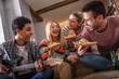 © BalanceFormCreative - Group of friends making fun at the home party.They sitting in living room and eating pizza.