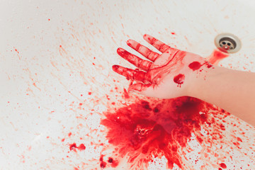 Wall Mural - Bloody hand of depressed woman in shower.