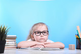 Fototapeta Panele - Back to school .Happy cute industrious child is sitting at a desk indoors. Kid is learning in class.quarantine.Kid is learning in home.