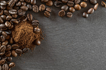 Beans for dark caffeine espresso on black food background. For cup of coffee drink in cafe. Brown roasted coffee seeds isolated for energy mocha, cappuccino ingredient. Copy space, top view