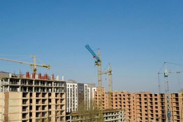 Construction and construction of high-rise buildings, the construction industry with working equipment and workers. View from above, from above. Background and texture