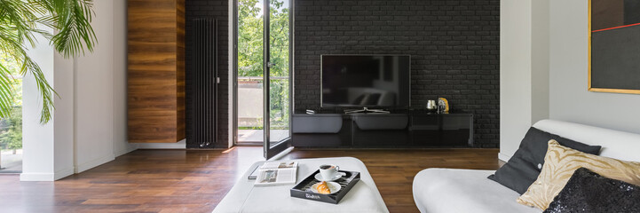 Living room with black brick wall, panorama