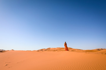 Wall Mural - A girl in a beautiful Moroccan dress. Merzouga Morocco.