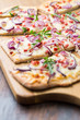 Flammkuchen - Traditional French dish tarte flambee cream cheese, bacon and onions