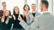 © yurolaitsalbert - rear view. business man standing in front of applauding business team