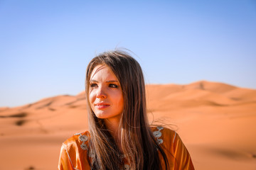 Wall Mural - A girl in a beautiful Moroccan dress. Merzouga Morocco.