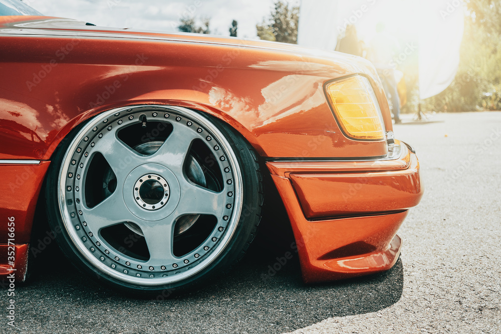 Tuned red sport car wheel, close up. Low rider sport auto. - obrazy, fototapety, plakaty 