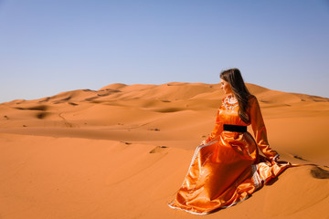 Wall Mural - A girl in a beautiful Moroccan dress. Merzouga Morocco.