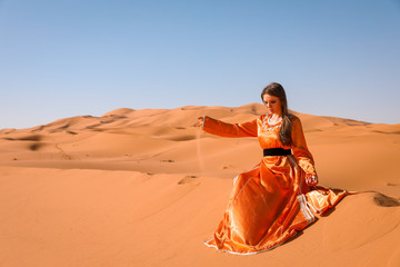 Wall Mural - A girl in a beautiful Moroccan dress. Merzouga Morocco.