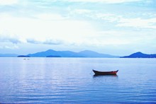 Lone Boat In Calm Blue Sea
