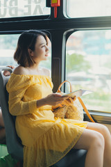 Wall Mural - Beautiful woman using tablet when sitting on the bus.