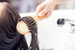 © Parilov - Master applies conditioner to hair using massage comb. Shampooing with special deep cleansing in beauty salon