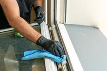 Profesional Cleaner Cleaning A Dirty Window Frame With A Micro Fiber Cloth