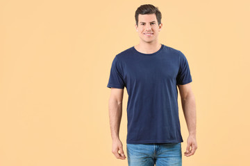 Man in stylish t-shirt on color background