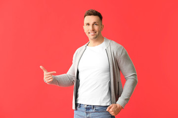 Wall Mural - Man in stylish t-shirt on color background