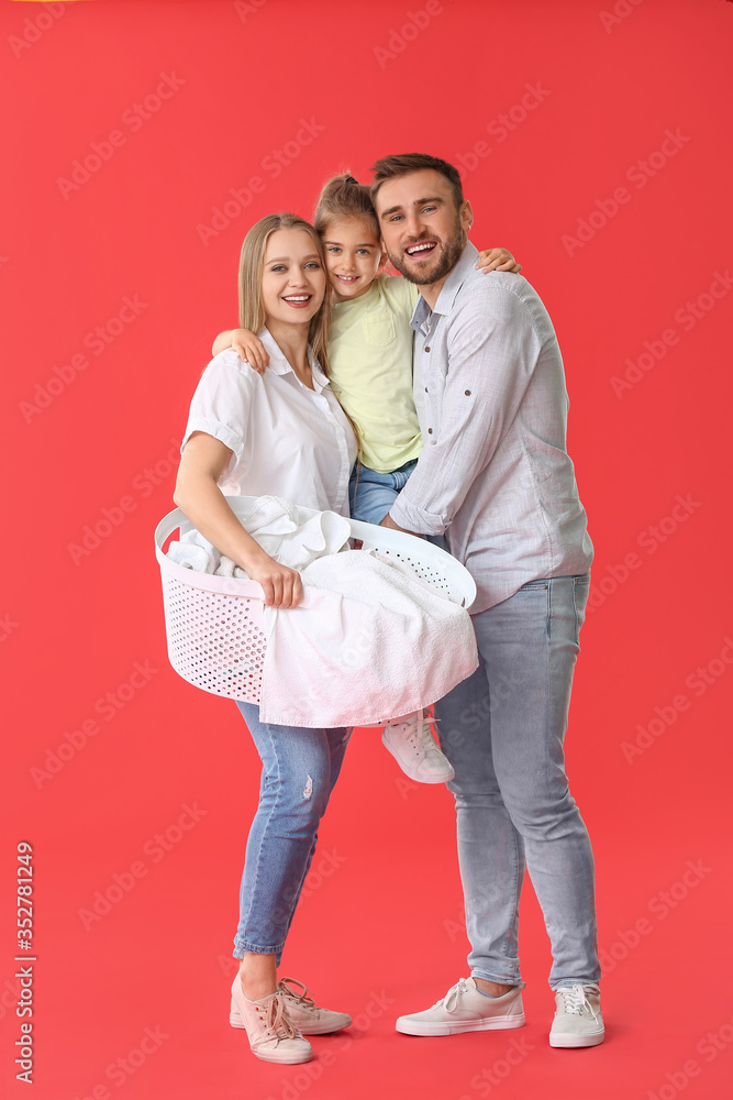 Family with laundry on color background