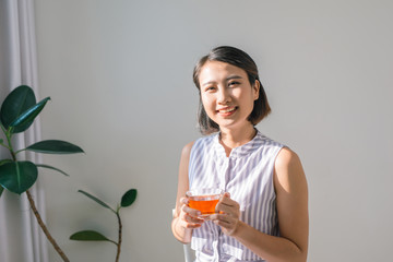 Wall Mural - Young asian girl feeling happy with her cup