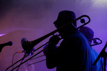 Jazz Musicians Performing In The French Quarter Of New Orleans, Louisiana, With Smoke And Neon Lights In The Background.