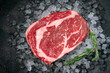 © Andrey - Raw fresh Rib eye beef steak on ice with herbs and rosemary, top view