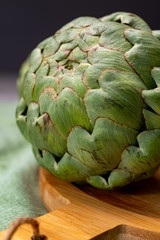 Big ripe uncooked green globe artichoks vegetables