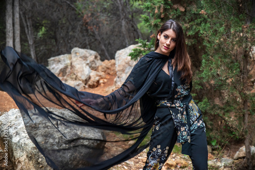 Cuadros en Lienzo young girl dressed in a tunic waving it in the wind in a forest