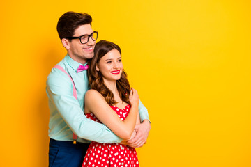 Wall Mural - Profile photo of attractive pretty lady handsome guy couple hugging look side empty space wear red dotted dress shirt bowtie retro clothes isolated yellow bright color background