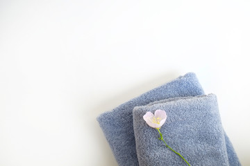 Wall Mural - Studio shot of two grey folded towels of different size isolated on white background with a lot of copy space for text. Top view, close up.