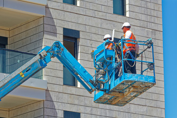 A construction worker is working with crane trucks.