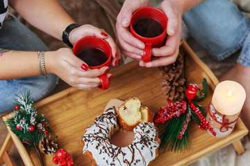 two red cups in hand and christmas decor