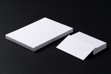 Sticker - White blank business cards on dark black background