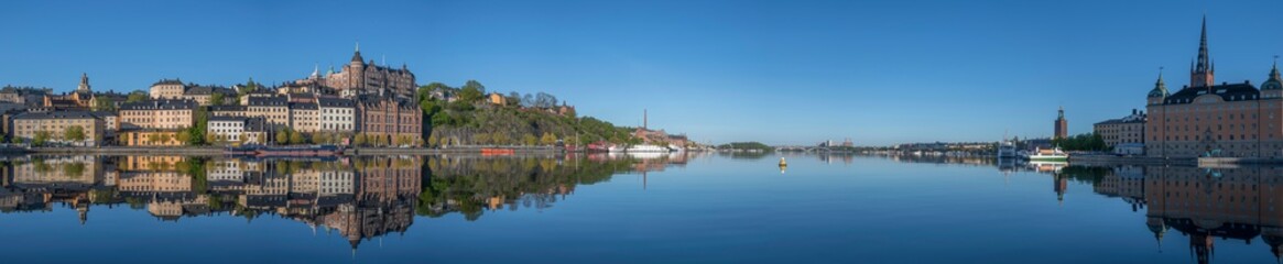 Sunny morning view over old house part of the district of Södermalm, above the waterfront at the bay Riddarfjärden and the sluice part in Stockholm. 