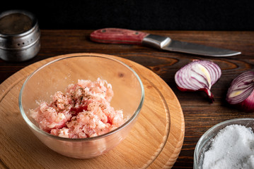 Minced chicken on wooden board.