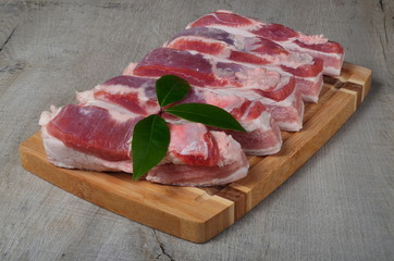 raw pork belly slice on a wooden board. Sliced pork on a cutting board