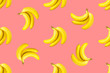 Seamless pattern from bundles of ripe yellow bananas on pink background. Tropical summer fruits concept. Template for wallpaper textile print product surface design