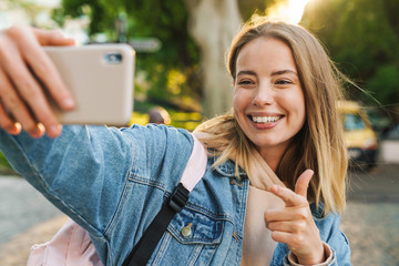 Wall Mural - Beautiful young blonde woman wearing denim jacket