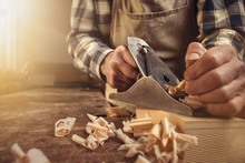 Hands Of A Carpenter Are Working With A Planer
