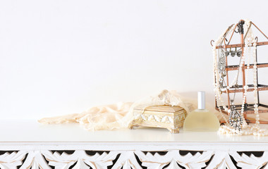 Wall Mural - Image of pearls and perfume over white vintage wooden table. For mockup, can be used for photography montage