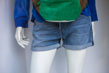 Wall Mural - Closeup of blue jeans short on mannequin in a fashion store showroom