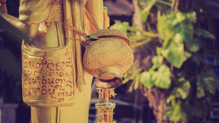 A basket behind a gold person statue