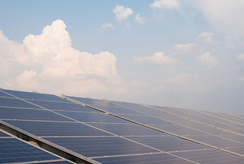 Solar panels and blue sky background.Solar cells farm on the roof.Photovoltaic modules for renewable energy.Save the earth and the energy with good environment concept.