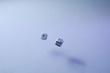 Two dice on white background flying