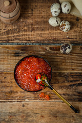 red caviar on a wooden background in Russian style