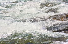 Rapid Spring River Flowing Over Rocks On Sunny Day, Forming White Water Waves, Closeup Detail - Abstract Nature Background