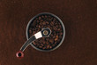 Vintage coffee grinder steeped in freshly ground arabica coffee beans