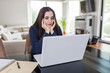 © zphoto83 - Young woman working form home on her laptop. Freelancer or online learning concept.